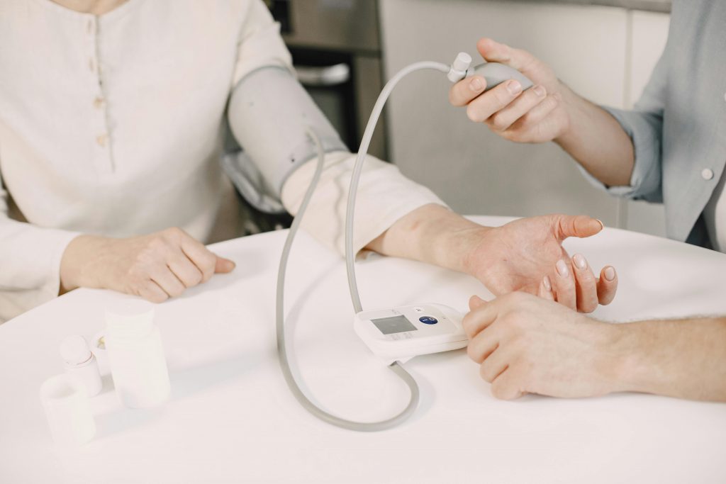 Our Services Close-up of blood pressure measurement at home highlighting healthcare equipment.