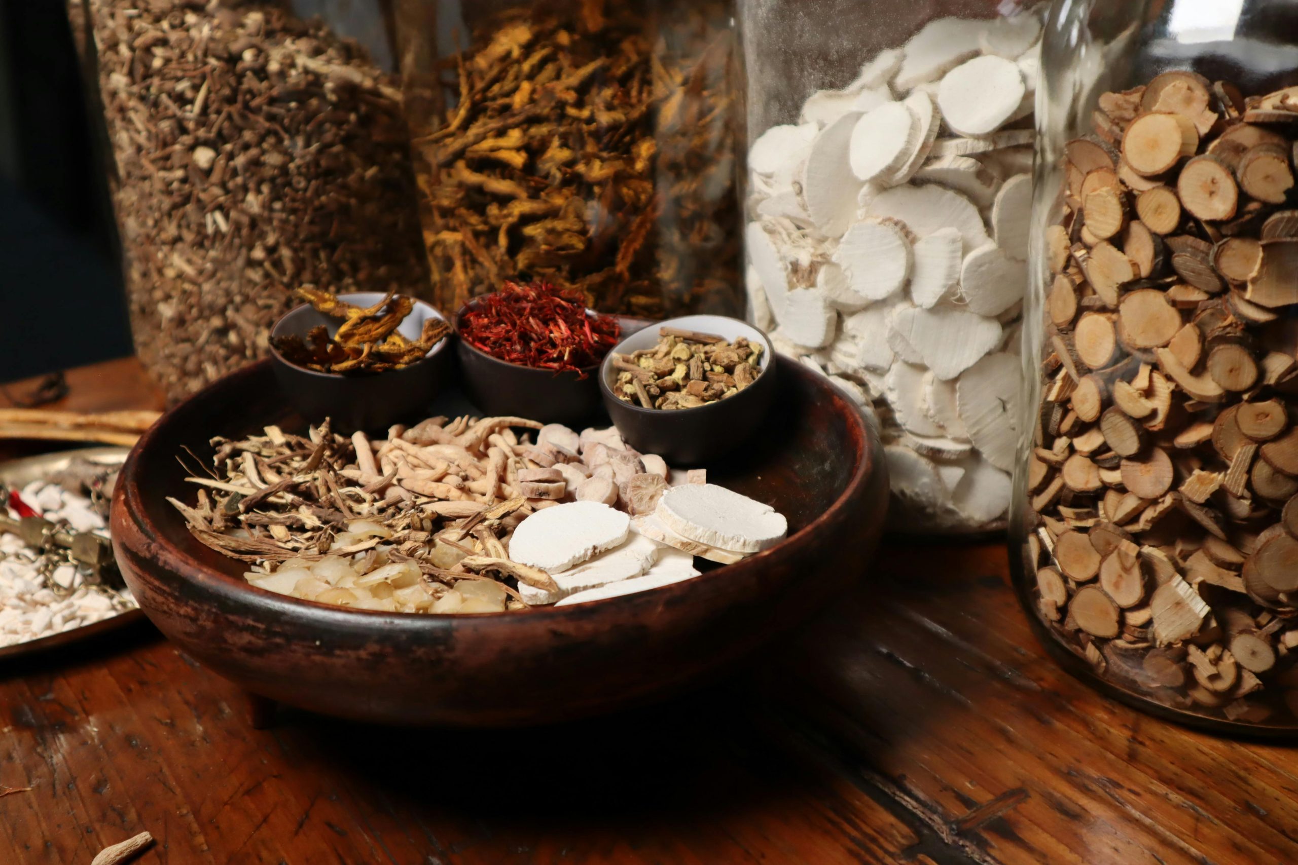 Traditional Chinese Medicine (TCM) Introduction A collection of assorted traditional Chinese herbs and spices in jars and bowls.